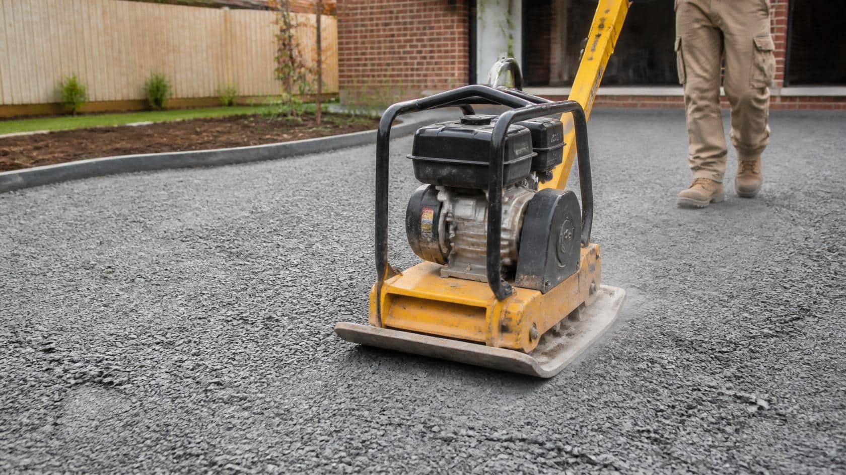 Compacting road base before laying pavers